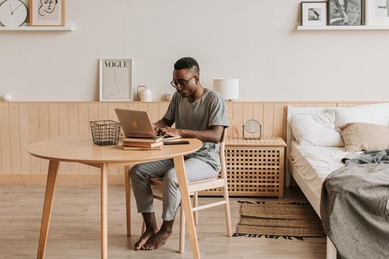 Man working at home on notebook - Pexels